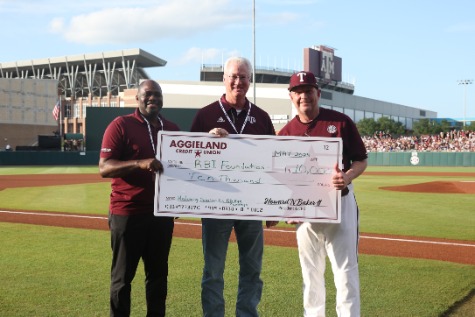 Three People Posing with a Large Check